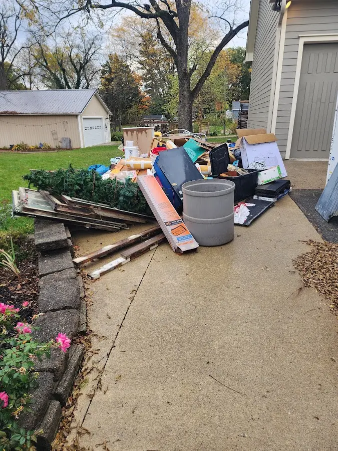 Dumpster being loaded with debris for 10 Yard Dumpster Rental in Dawsonville